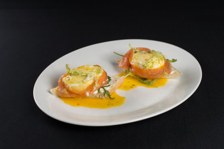 A delicious eggs benedict with lightly salted salmon and sauce.の写真素材