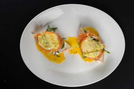 A delicious eggs benedict with lightly salted salmon and sauce.の写真素材