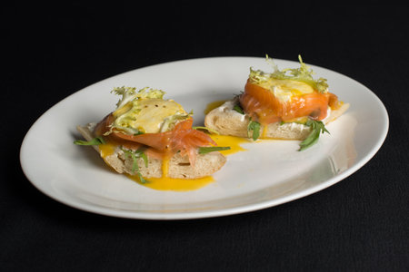 A delicious eggs benedict with lightly salted salmon and sauce.の写真素材