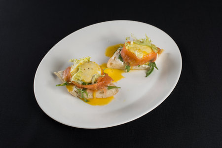 A delicious eggs benedict with lightly salted salmon and sauce.の写真素材