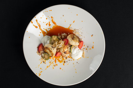 Cottage cheese pancakes with sour cream and almond flakes and sea buckthorn-orange sauceの写真素材