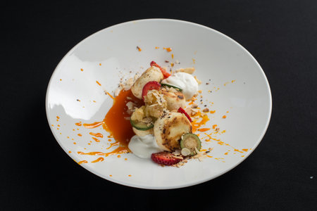 Cottage cheese pancakes with sour cream and almond flakes and sea buckthorn-orange sauceの写真素材