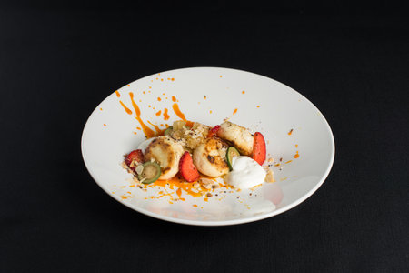 Cottage cheese pancakes with sour cream and almond flakes and sea buckthorn-orange sauceの写真素材
