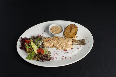 Stuffed trout with mushrooms sauce and saladの写真素材