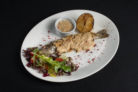 Stuffed trout with mushrooms sauce and saladの写真素材