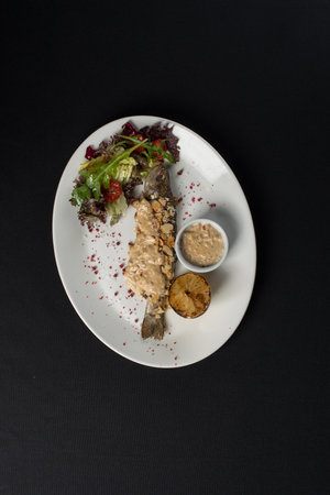 Stuffed trout with mushrooms sauce and saladの写真素材