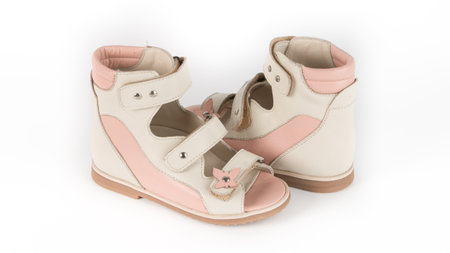 childrens beige orthopedic sandals on a white backgroundの写真素材