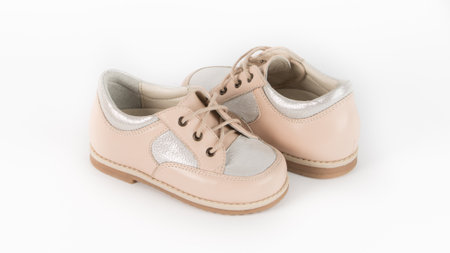 childrens beige orthopedic shoes on a white backgroundの写真素材