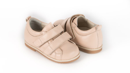 childrens beige orthopedic shoes on a white backgroundの写真素材