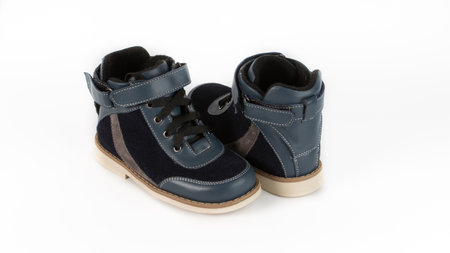 childrens blue orthopedic shoes on a white backgroundの写真素材