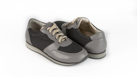 childrens gray orthopedic lacing shoes on a white backgroundの写真素材