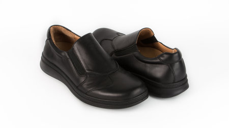 childrens black orthopedic shoes on a white backgroundの写真素材