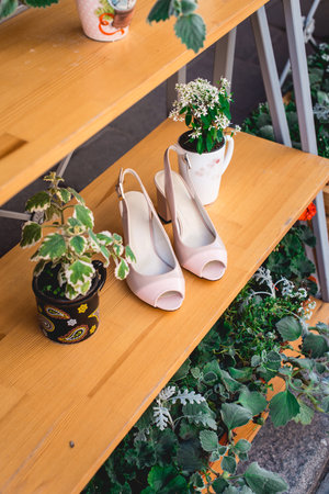 Women shoes, glamour beige high heel shoes on wooden background. Advertising womens shoesの写真素材
