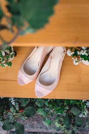 Women shoes, glamour beige high heel shoes on wooden background. Advertising womens shoesの写真素材