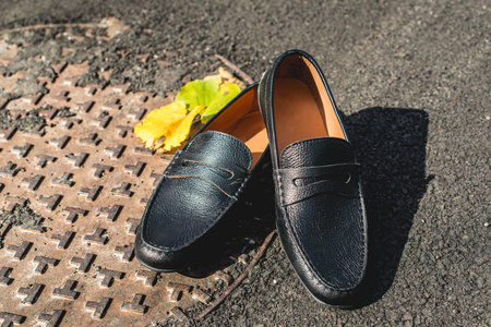 mens shoes moccasins black color. photo on the streetの写真素材