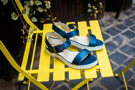 Pair of female summer blue sandals. Concept art womens shoes. style footwear.の写真素材