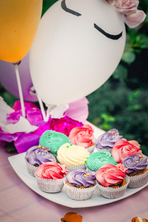 Colorful cakes with sweet icing. Cakes on a served for a birthday party table.の写真素材