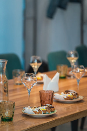 served table for food and vine tasting. Eclairs with different ganache and icing with different toppingsの写真素材