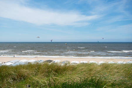 empty sandy beach. kite surfers on the water of North Sea, Zandvoort, Netherlandsの写真素材
