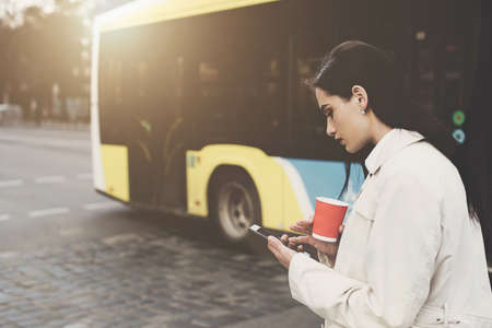 A woman on the street uses a mobile phone. online shopping. use of mobile applications.の写真素材