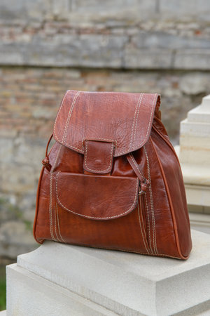 Orange leather backpack on the snone monumentの写真素材