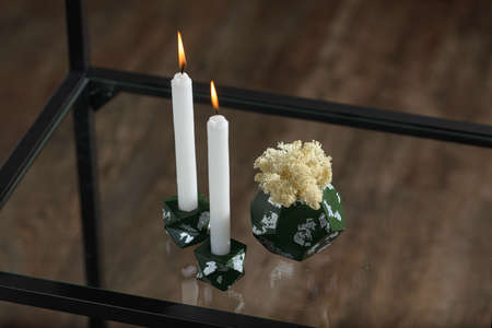 Two stone Candle Holder with abstract smudges, green concrete with silver flame. selective soft focus. White moss in a concrete potの写真素材