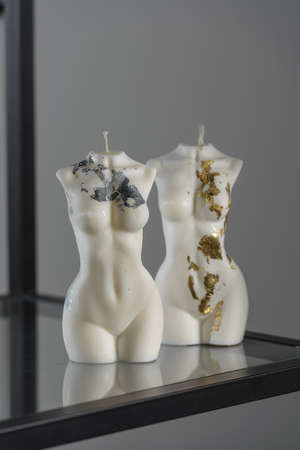 Two white candles in the shape of a womans bodyの写真素材