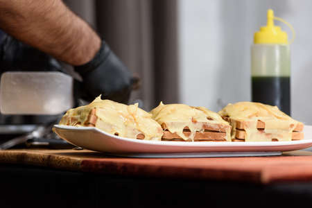 Francesinha, traditional Portuguese sandwich originally from Porto. National cuisine concept. the chef prepares a dish at restaurantの写真素材
