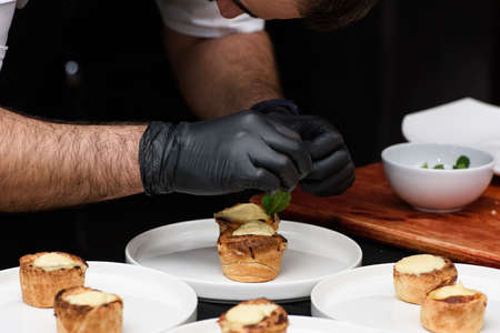 Typical Portuguese custard pies Pastel de Nata or Pastel de Belem. traditional portuguese pastry. On a black tableclothの写真素材