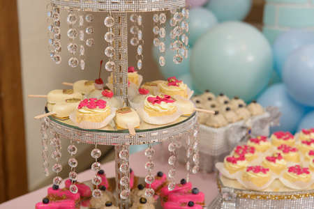Dessert table for a party. cupcakes, sweetness and fruitsの写真素材