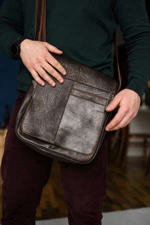 close-up photo of brown messanger leather bag on mans shoulderの写真素材