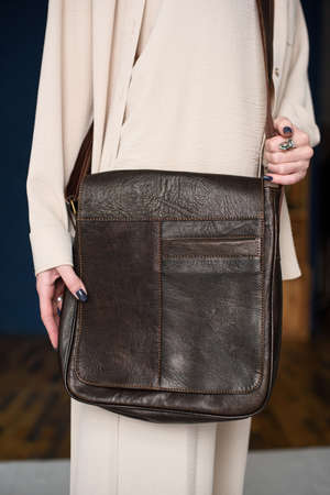 close-up photo of brown messanger leather bag on womans shoulderの写真素材