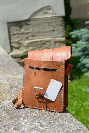 Outdoor photo of a yellow leather Messenger bag.の写真素材