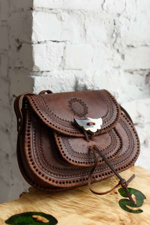 small brown womens leather bag with a carved pattern. selective focusの写真素材
