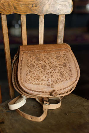 small brown womens leather bag with a carved pattern. selective focusの写真素材