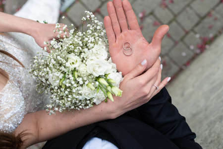 man hands holding wedding rings