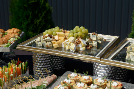 Cheese plate with variety of appetizers on tableの写真素材