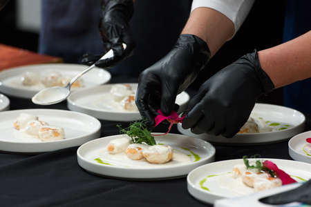 the chef prepares a dish of fish balls in a creamy sauceの写真素材