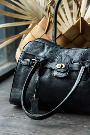 close-up photo of black leather bag on a wooden tableの写真素材