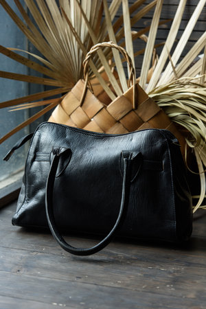 close-up photo of black leather bag on a wooden tableの写真素材