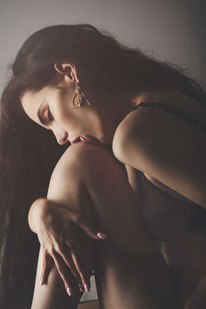 Sensual young woman wearing black lingerie isolated on white. portraitの写真素材