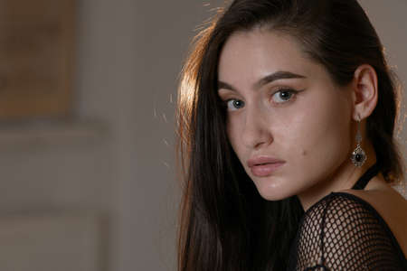 Close-up portrait of a young brunette woman in black lingerieの写真素材