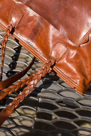 close-up photo of orange leather bag on a metal texture backgroundの写真素材