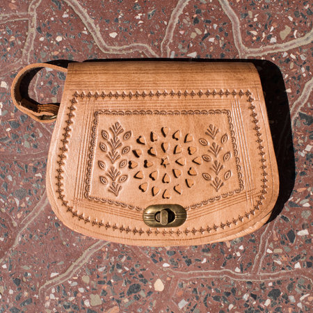 small yellow womens leather bag with a carved patternの写真素材