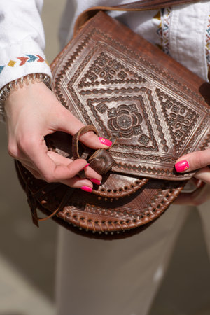 small brown womens leather bag with a carved pattern. selective focusの写真素材