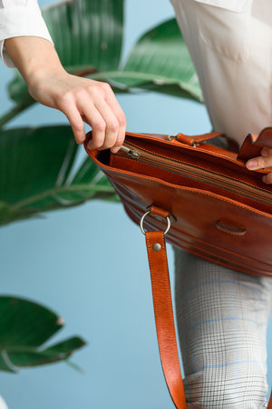 close-up photo of orange leather bag in a womans handsの写真素材