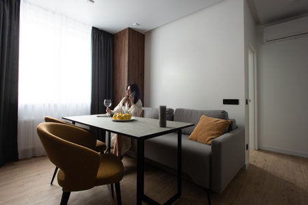 beautiful woman reading a magazine in the kitchen. apartment after renovationの写真素材