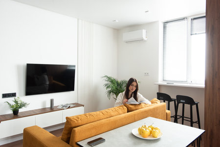 beautiful woman reading a magazine in the kitchen. apartment after renovationの写真素材
