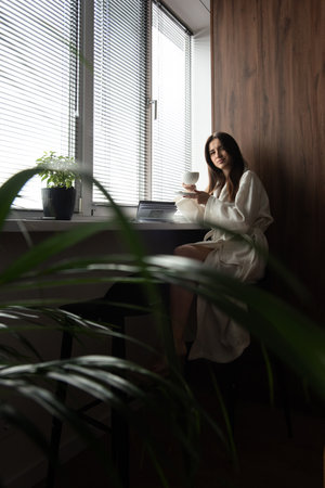 woman drinking coffee in the morning at home. Beautifull morning at cozy homeの写真素材