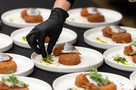 chief serving herring with potato Kroket croquette Dutchs favourite snack deep-fried ragout filled snack coated with breadcrumbsの写真素材